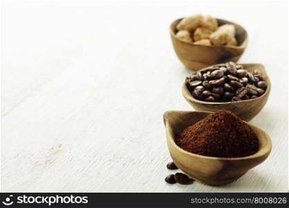 Wooden Bowls with coffee beans, sugar and ground coffee