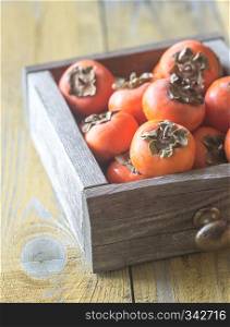 Wooden box of fresh persimmons