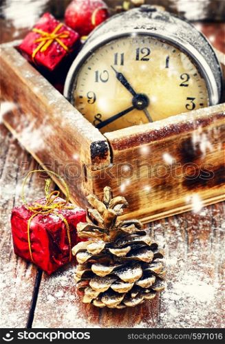 Wooden box with alarm clock,Christmas decorations,pinecone.The image is tinted.