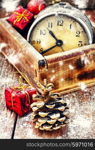 Wooden box with alarm clock,Christmas decorations,pinecone.The image is tinted.