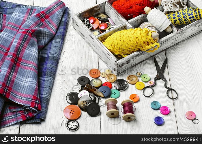 Wooden box with sewing thread,buttons and lace