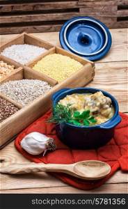 wooden box with varieties of cereals on the background of the cooked pilaf.. Uzbek pilaf