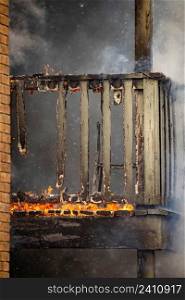 Wooden brick house balcony open fire burning disaster outdoors. Wooden brick house balcony open fire burning disaster