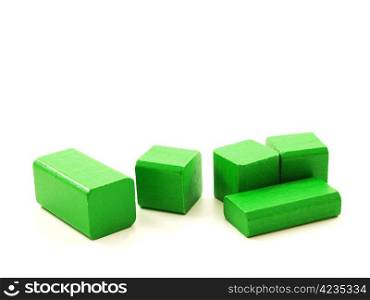 Wooden brick pieces of green color, isolated towards white