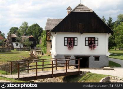 Wooden bridge and farm house in Kumrovets, Croatia