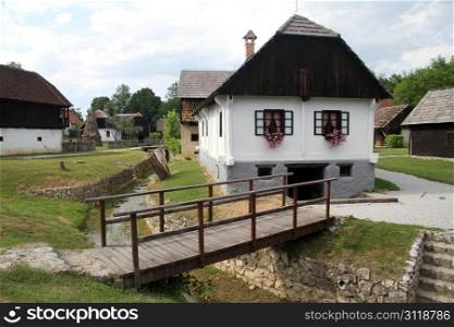 Wooden bridge and farm house in Kumrovets, Croatia