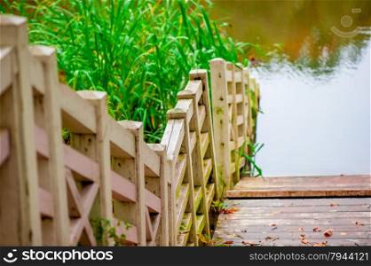 wooden bridge and the water of the lake in autumn