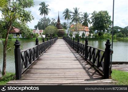 Wooden bridge and wat Traphang Thong, Sulhotai, Thailand