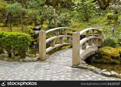 Wooden bridge crossing stream in Japanese Garden