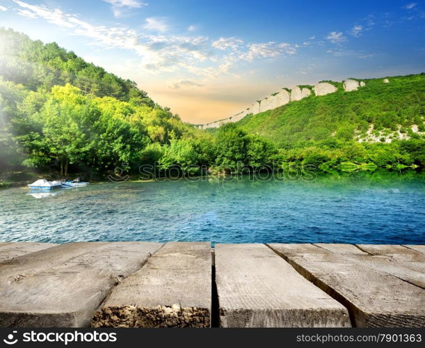 Wooden bridge in a calm backwater in mountains