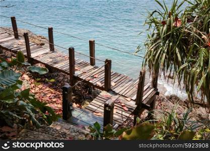 Wooden bridge on a rock by the sea