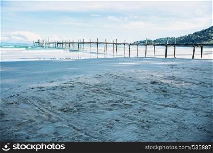 Wooden bridge on the beach with beautiful at sky.