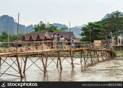 Wooden bridge over river song to riverside guesthouse, Vang vieng, Laos.
