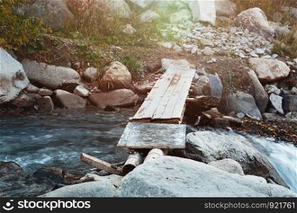 Wooden bridge over small river. Horizontal photo