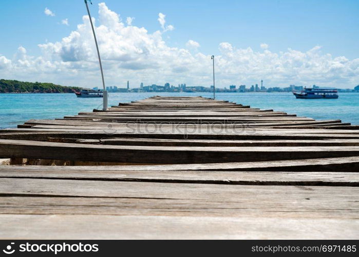 wooden bridge pier in the sea at Khao Lan, opposite with Pattaya city beach, Thailand