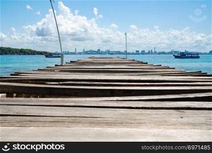wooden bridge pier in the sea at Khao Lan, opposite with Pattaya city beach, Thailand
