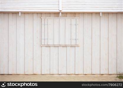 Wooden building house on beach. Window on wooden white house wood background