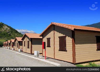 Wooden bungalow houses in camping area in Pyrenees mountains