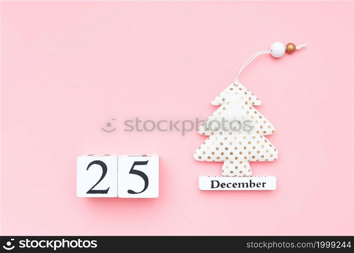 Wooden calendar December 25, textile christmas tree on pink background. Merry christmas concept. Top view Flat lay Template for design, greeting card, postcard.. Wooden calendar December 25, textile christmas tree on pink background. Merry christmas concept. Top view Flat lay Template for design, greeting card, postcard