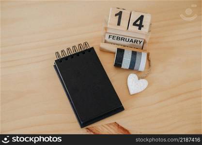 Wooden calendar on February 14 with a heart. Happy Valentines Day concept