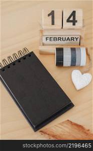 Wooden calendar on February 14 with a heart. Happy Valentines Day concept