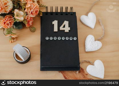 Wooden calendar on February 14 with roses and heart. Happy Valentines Day concept