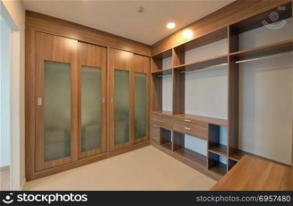 wooden carbinets in dressing room in modern home, interior desig. wooden carbinets in dressing room in modern home, interior design. wooden carbinets in dressing room in modern home, interior design