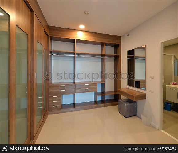 wooden carbinets in dressing room in modern home, interior desig. wooden carbinets in dressing room in modern home, interior design. wooden carbinets in dressing room in modern home, interior design