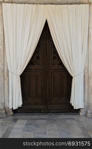 Wooden carved church gate and drapes. Metropolitan cathedral of Athens, Greece.