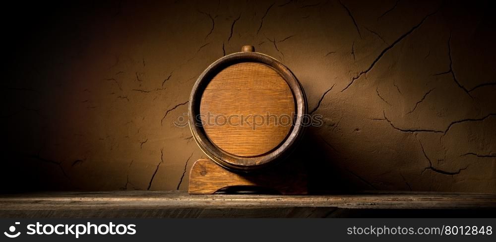 Wooden cask near clay wall in cellar