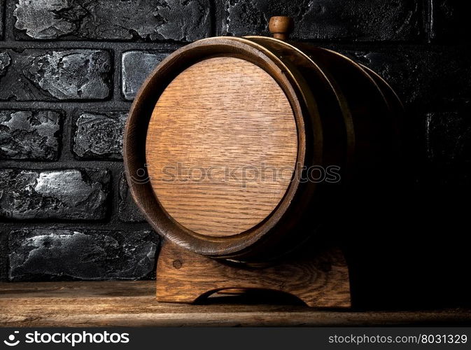 Wooden cask on table near black brick wall