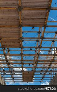 Wooden Ceiling Structure: Building with Modern Architectural Design and Blue Sky in background