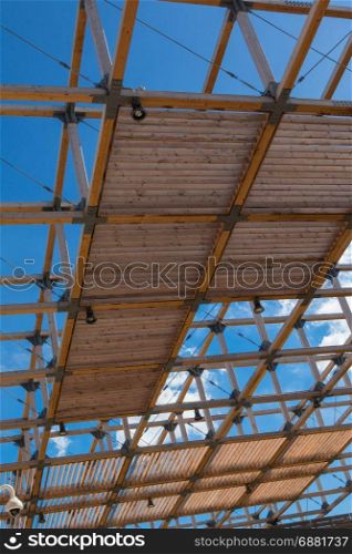 Wooden Ceiling Structure: Building with Modern Architectural Design and Blue Sky in background