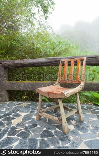 Wooden chair on the balcony. Decking made of stone The outside terrace is a tree of moist air.