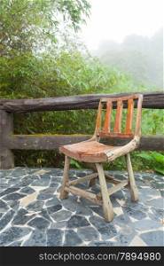 Wooden chair on the balcony. Decking made of stone The outside terrace is a tree of moist air.