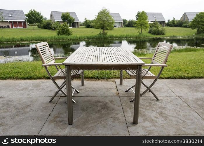 wooden chairs and table to relax on holiday near the water