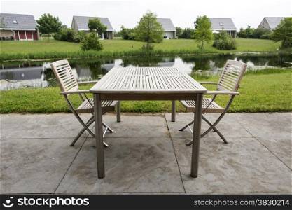 wooden chairs and table to relax on holiday near the water