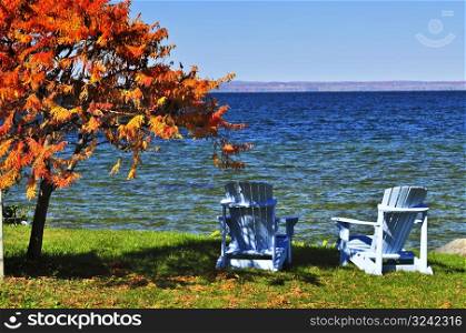 Wooden chairs on autumn lake