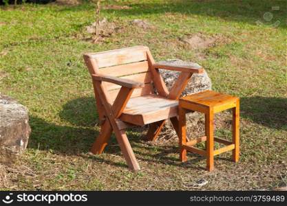 Wooden chairs placed on the lawn. Sunny in the morning from the front.