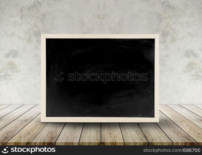 Wooden chalkboard empty table top with cement background, can be used for display your products.