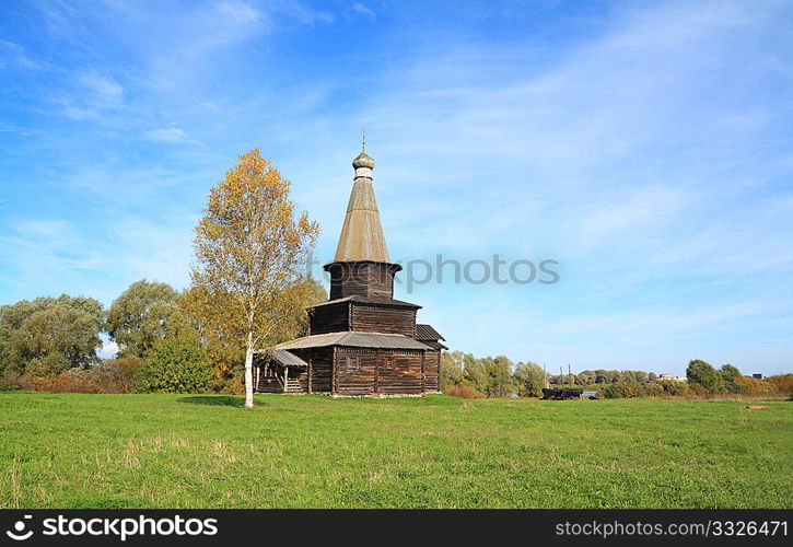 wooden chapel on green field