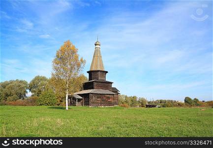 wooden chapel on green field