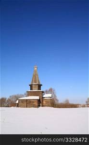 wooden chapel on winter field