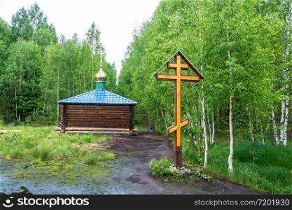 Wooden chapel with a Golden dome on the sacred source flux in the Makariev district, Kostroma region, Russia.