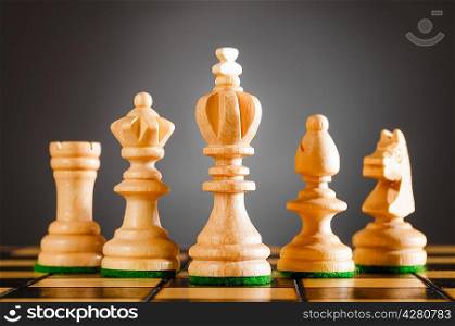 wooden chess pieces on gray background