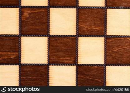 Wooden chessboard close up for background