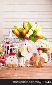 Wooden chickens figures - Easter decorations on the table. Wooden chicken