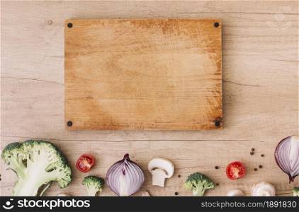 wooden chopping board with broccoli tomatoes onion mushroom black pepper table. Resolution and high quality beautiful photo. wooden chopping board with broccoli tomatoes onion mushroom black pepper table. High quality and resolution beautiful photo concept