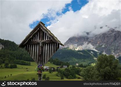 Wooden Christian Cross and Italian Dolomites Alps in Background in Summer Time. Wooden Christian Cross and Italian Dolomites Alps in Background