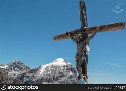 Wooden Christian Cross and Italian Dolomites Alps in Background in Summer Time